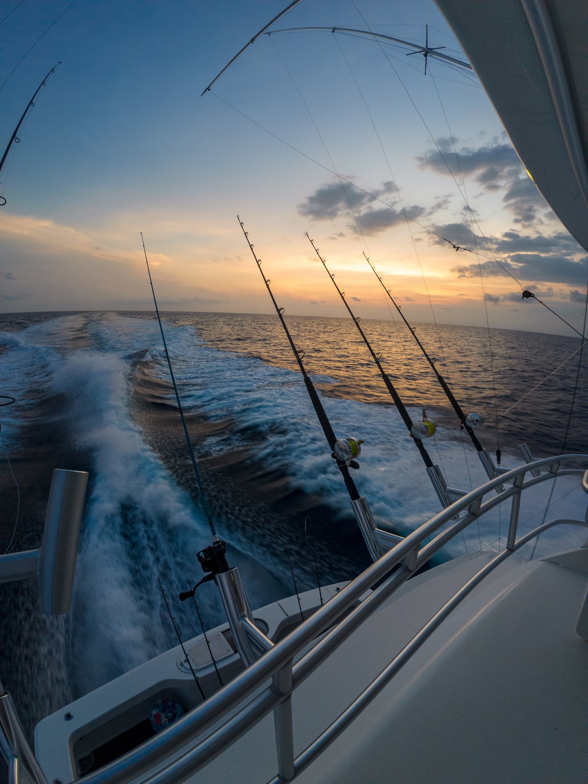 Sport fishing yacht off the coast with dramatic ocean skies